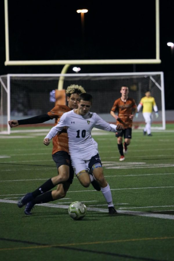 Cesar Frias 20 slides in to steal the ball from a McNeil player. Frias passed the ball to a teammate.