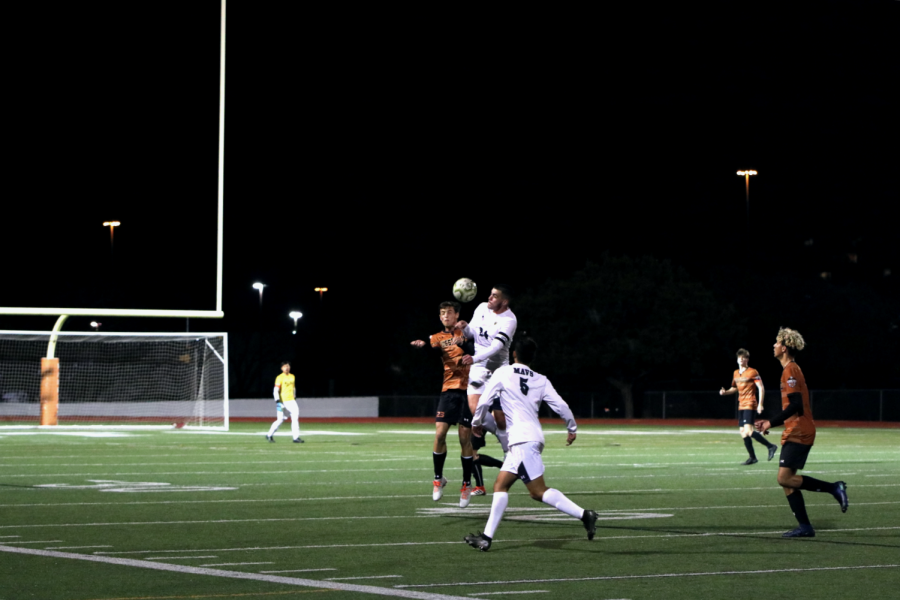 Anthony Bibbo 20 heads the ball into the air. Bibbo passed the ball to teammate Cesar Frias 20.