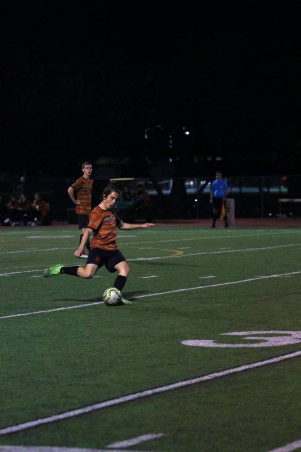 Niko Djordjevic 21 kicks the ball downfield towards his teammates. Djordjevic scored three out of the four goals in the game.