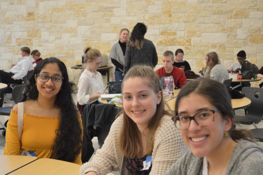 Arundhati Subramanian 21, Rosie Deal 22, and Marina Oquendo 22 rest in the cafeteria after being judged. The gallery walk in the gym was going to start in a few minutes.