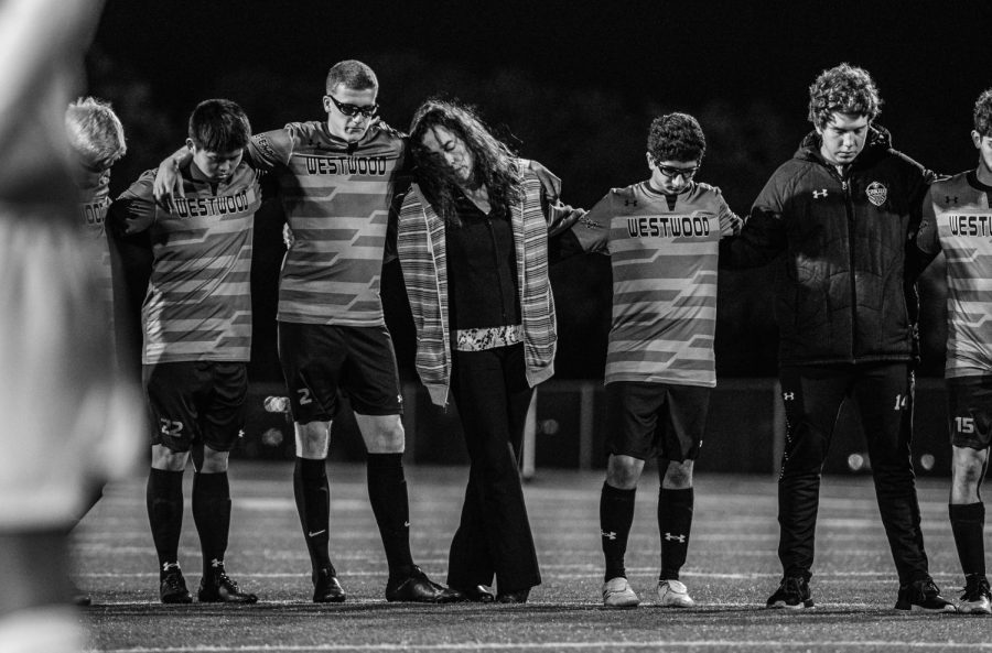 Louis Niemerg 21, his host mother, and the team stand for a moment of silence to honor his brother who passed away the day before the game. During the game, Niemerg scored one goal and honored the life of his brother.