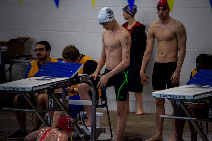 Max Vinnik 22 prepares for the grueling 200-yard freestyle, with the words Swim4Shauna engraved down his left arm. Vinnik qualified for finals with a time of 1:48.76.