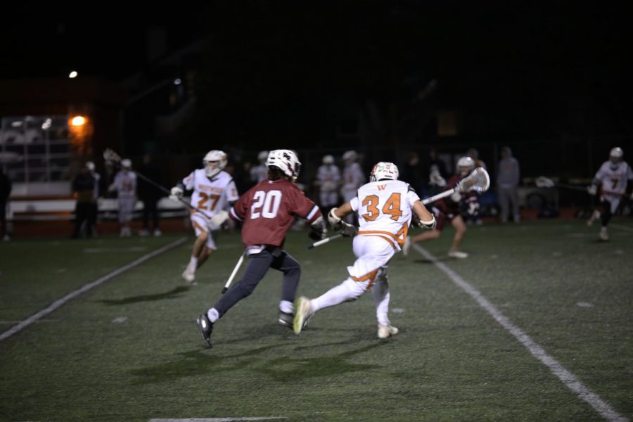 Jack Baddour 20 attempts to prevent an enemy Dragons advance during a defensive play. The Dragons scored several times during the third quarter, creating an enormous lead.