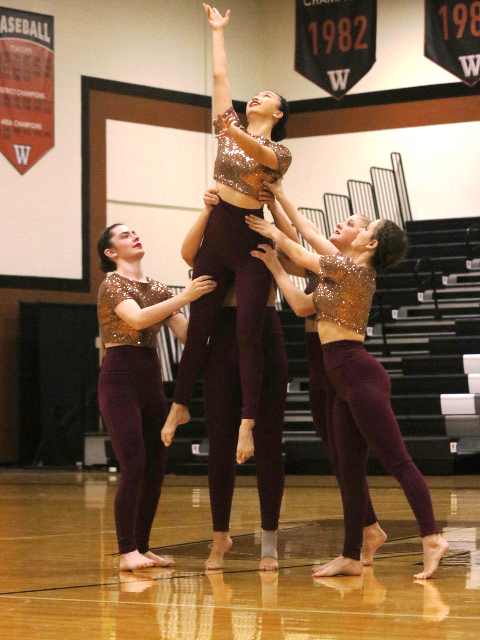 The SunDancer officers work together to lift Ashley Zhang 20. 