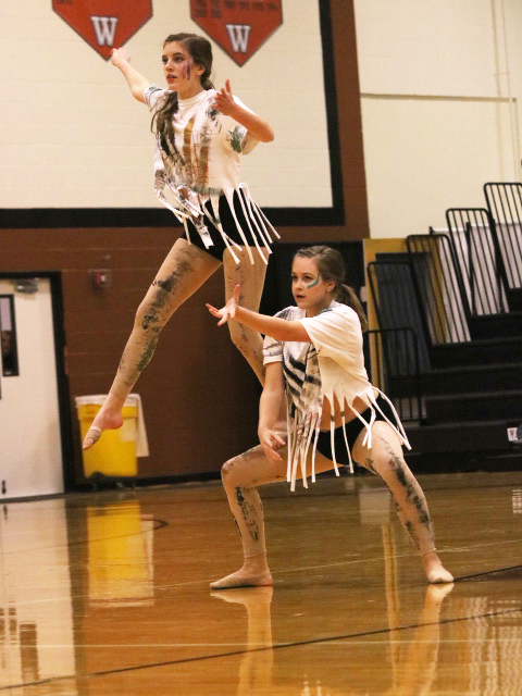 Lily Sayre 21 lifts off of Claudia Indriago 21 in their self choreographed duet. The duo made homemade costumes using paint and glitter and used the same concept for their makeup. 