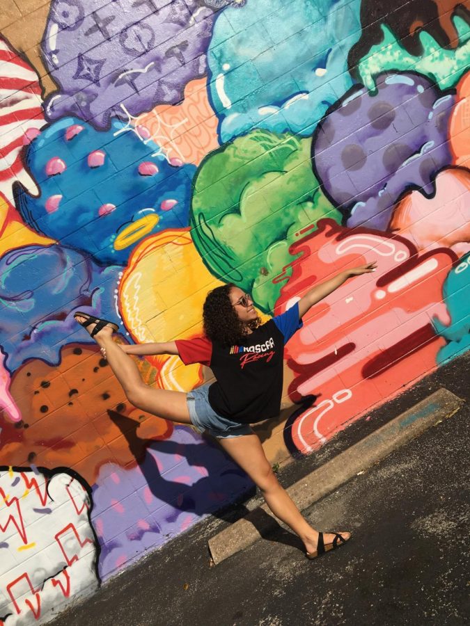 Veronika Croan 22 shows off her dance skills in front of colorful street art over the summer. Croan practices her moves in and out of school.