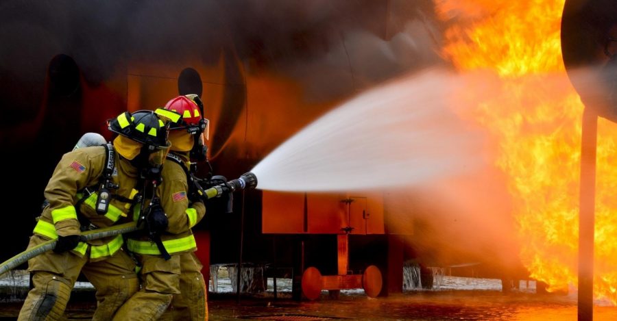 Firefighters combat an industrial fire.
