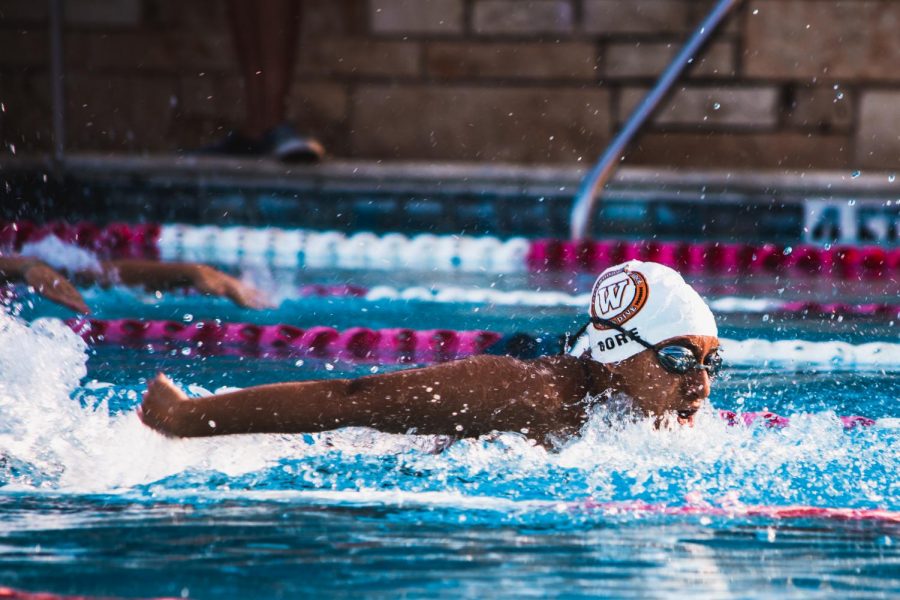 Shireen Gore 22 races the 100-yard butterfly on Friday, Sept. 25. Gore and her team in the 200-yard medley were able to place in first in this tri-meet.