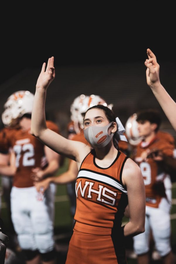 After the win, cheerleader Claire Fleming 21 puts her hand up in honor of the schools alma mater. The song is played at the end of every win, as well as at the end of pep rallies.