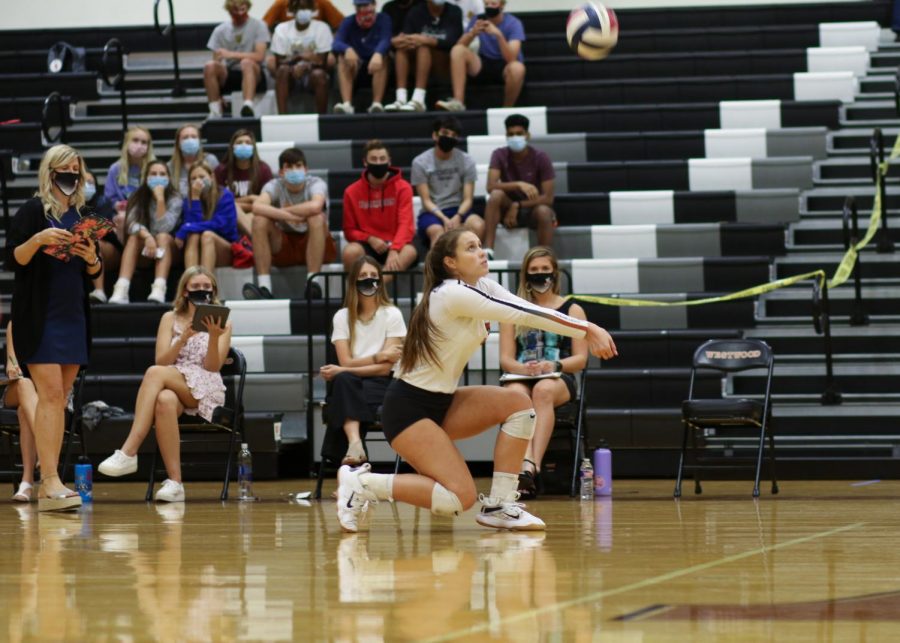 Kneeling, Abby Gregorczyk '21 gets ready to bump the ball to someone else on her team against Hutto on Friday, Oct. 2. Due to a positive COVID-19 test occurring in the team, play will be postponed until at least Saturday, Oct. 17.