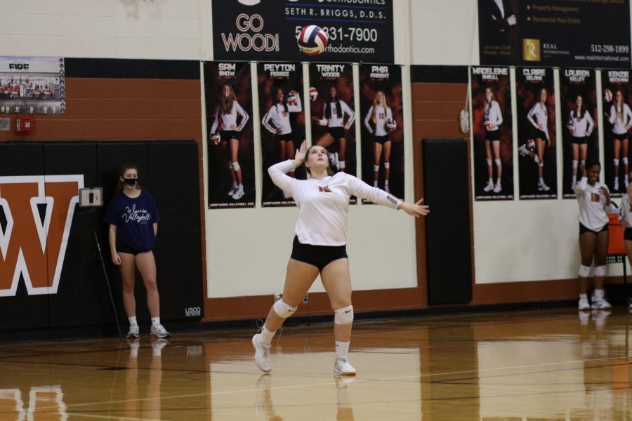 Winding up, Lauren Kelley 21 prepares to serve the ball. Despite their best efforts, the Warriors ended up giving the point to Hutto during this play.