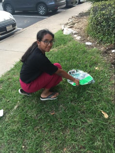 Sneha Nangunoori in '23 cleans waste in her community.