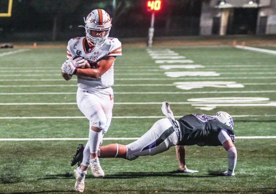 Making his second touchdown of the night, Robbie Jeng 21 escapes the Raiders defenders in the end zone. This was the last touchdown the Warriors scored in the game.