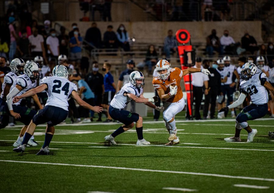 Surrounded by McNeil defenders, wide receiver Robbie Jeng 21 turns upfield after picking up a first down. Despite Jengs record-breaking performance against Hutto the following week, the Warriors fell to the visiting Hippos, eliminating them from playoff contention.