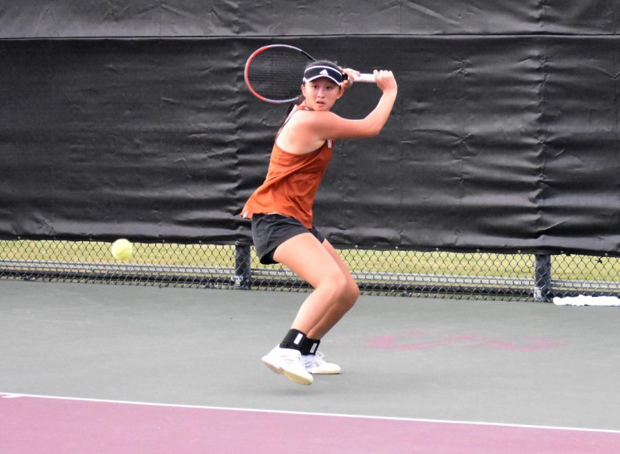 Advancing inwards on the ball, Jessica Lu 21 maneuvers her racket face in preparation to hit a short trajectory backhand slice shot. Lu is one of six tennis players to advance to the State tournament later this month.