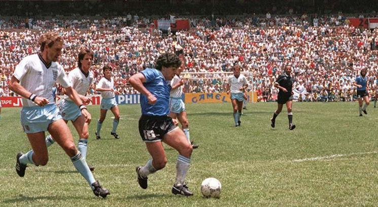 Diego Maradona dribbles past England defenders in the 1986 World Cup. Maradona, who passed away on Wednesday, was widely considered as one of the greatest soccer players of all time. Photo courtesy of Wikimedia Commons.