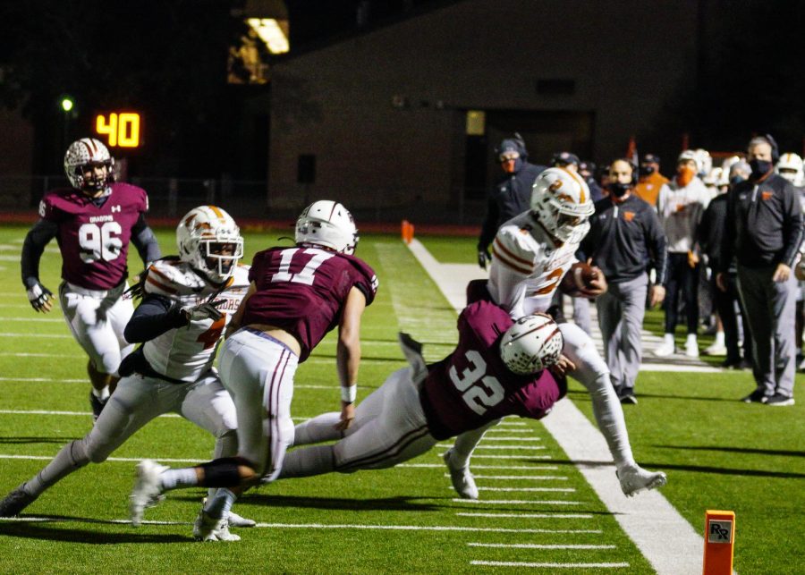 After making it past many Dragon defenders, RJ Martinez '21 is tackled. He gained over ten yards this play.