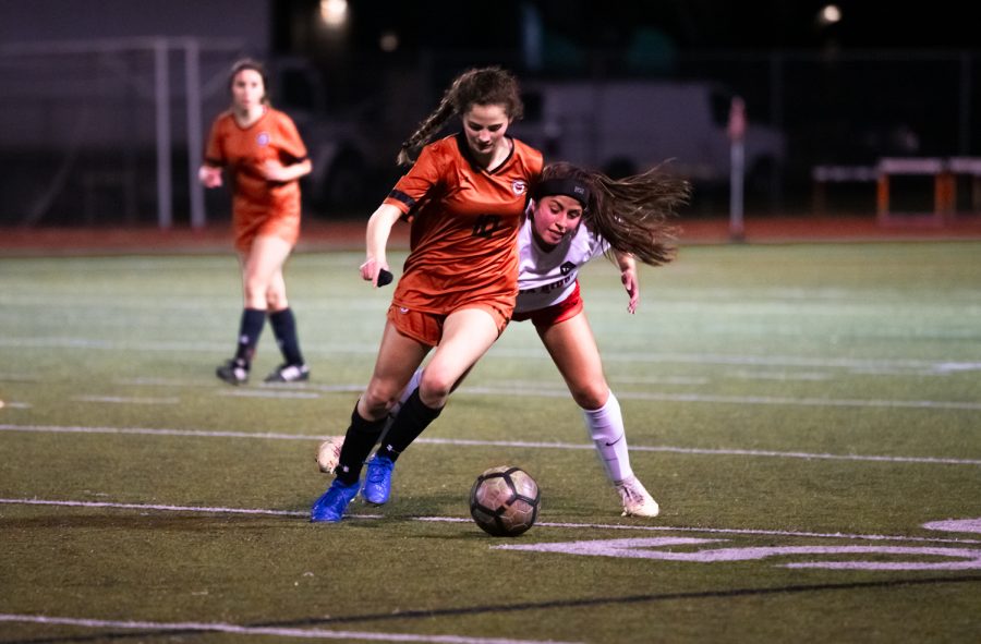 With an opposing right upsides her, midfielder Hailey Martinez 21 dribbles the ball in attempt to maintain possession of the ball. Martinez would maintain possession. In the last fourteen minutes of the game, the Warriors would make two goals, closing out their win 3-0.