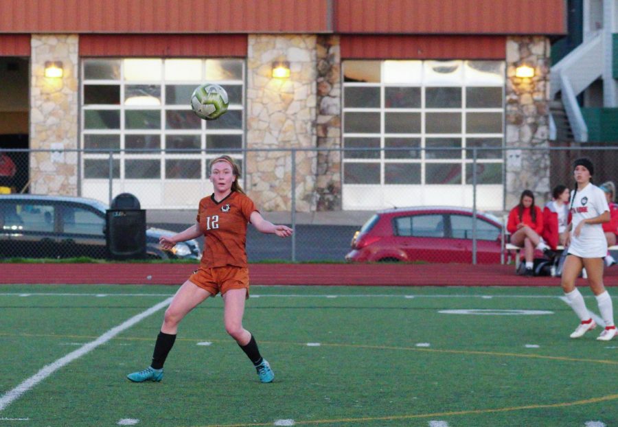 After finally getting open, Abby Burgett 23 prepares for a header. This move helped Burgett get the ball over opponents and to a teammate.