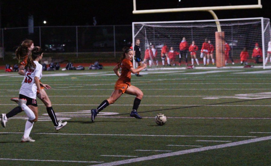 Sprinting past the ball, Gabriella Ziegler 23 saves the ball from going out of bounds. She then passed it back to teammate Katrina Savoie 23 to get it away from the sideline and opponents.