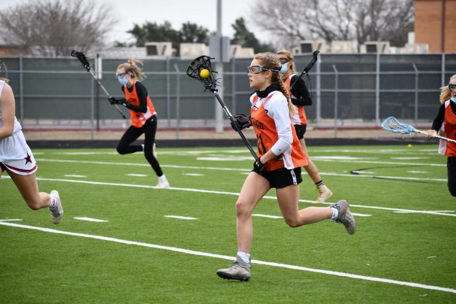 Bridgette Moravec 24 makes a fast break down the midfield with the ball in her stick. Moravec gained possession after a hard defensive fight from the Warriors against Prosper. 