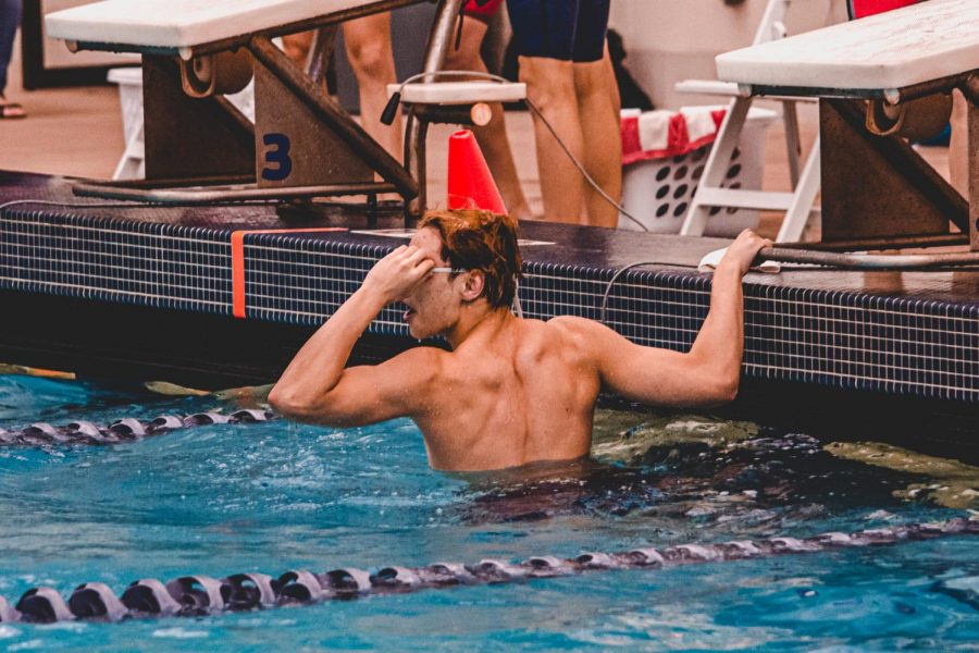 After destroying the A-final by over 3 seconds in the 100yd freestyle, Sonny Wang (23) looks at the scoreboard. With a time of 44.28, Wang is seeded first for the State meet.