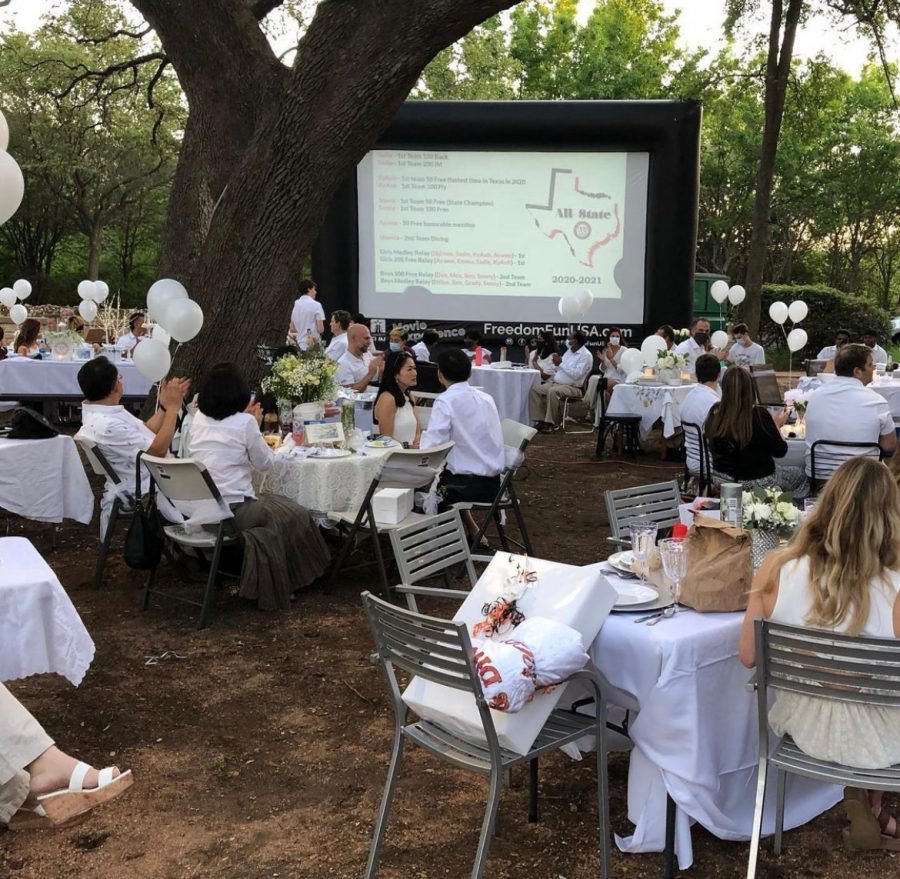 The warriors and their family sit and attentively listen to the All State winners. Each family brought their own picnic table and food to minimize the spread of germs. 
