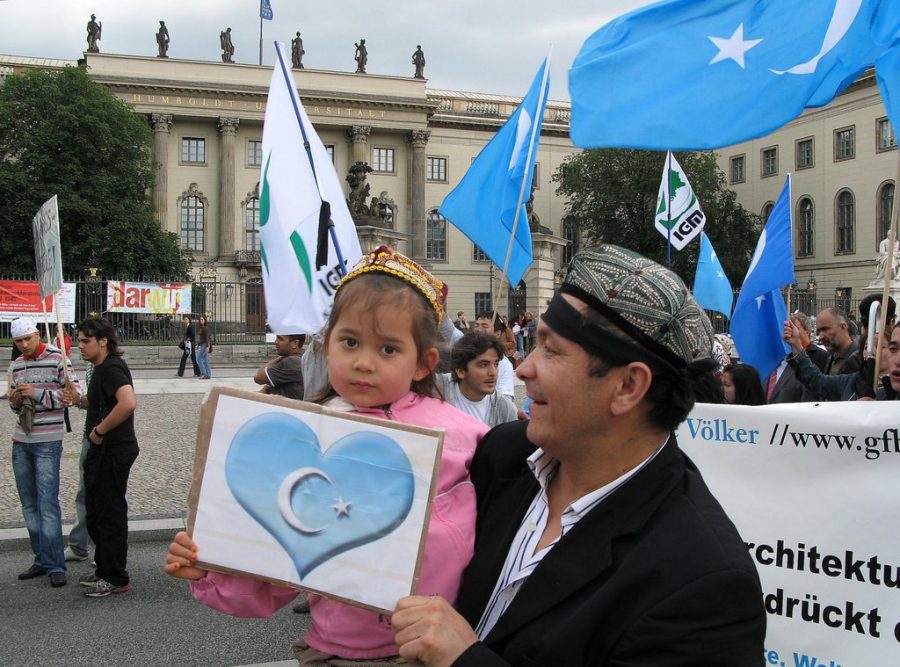 A young girl holds up a sign supporting Uighurs in China. Criticism of the Chinese governments oppression of Uighurs has been increasing internationally. Photo courtesy of langkawi.