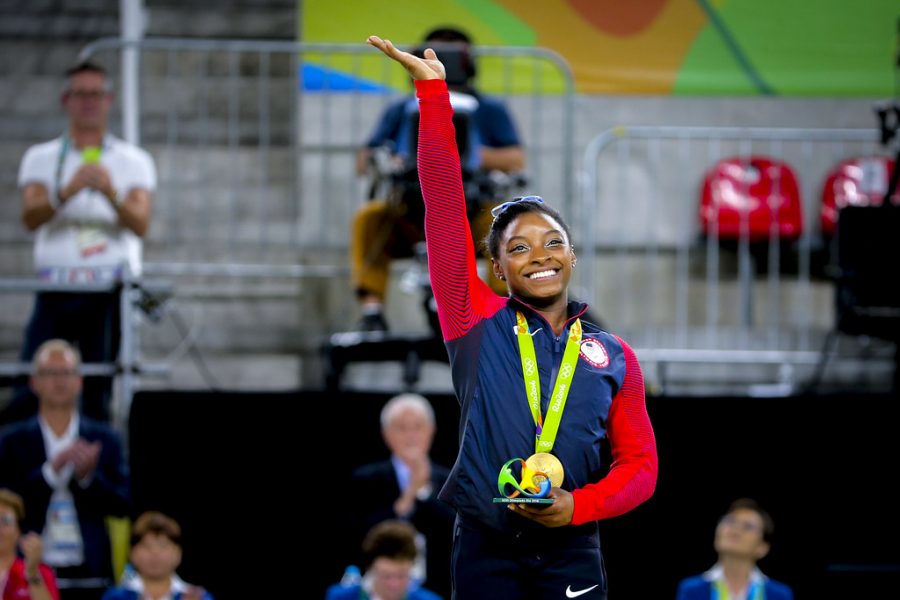 Simone Biles waves to the audience after winning a gold medal at the 2016  Olympics held at Rio de Janeiro, Brazil. Photo courtesy of Danilo Borges.