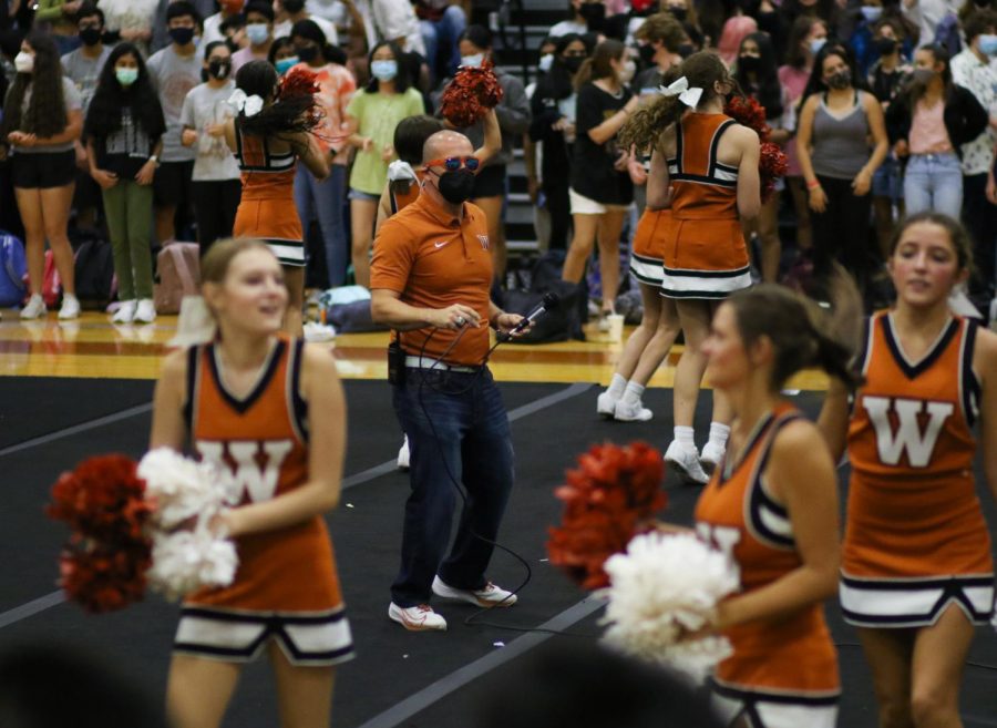 Dr. Acosta dances to the beat of the cheerleaders chants. The pep rally provided the school a way to start the new year.
