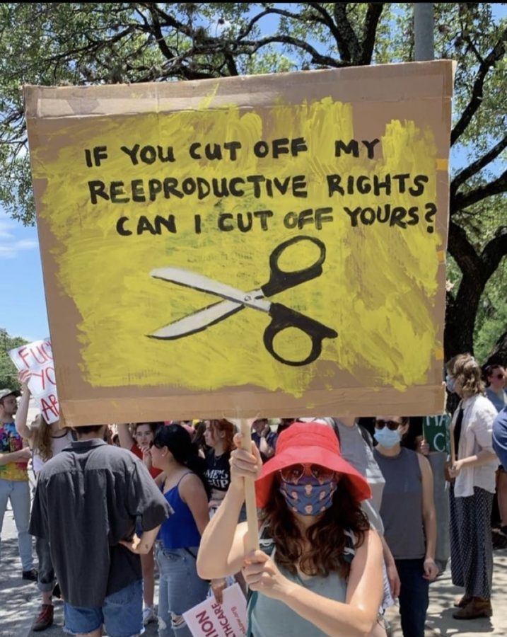 Westwood alumni Amelia Sadler attends a June rally, protesting Abbots abortion laws. She missed her own graduation to attend the protest, where she captured photos of many powerful signs.