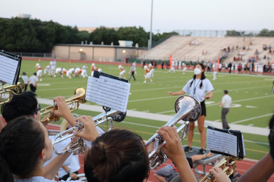 Led by drum major Julia Fang ‘22, the Westwood Warrior Marching band trumpets blast out stand tunes at their second football game of the 2021-2022 marching season on Sept. 3. Thanks to Kim and four other student conductors, they later performed at halftime without a metronome for the first time. 
