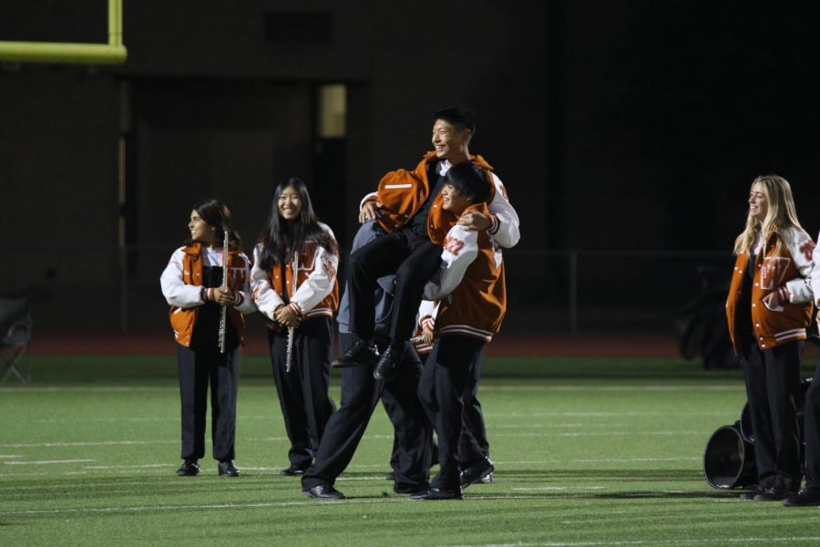 Joshua Lee 22 is lifted by his friends during half time. It was the bands senior night so every senior was recognized.