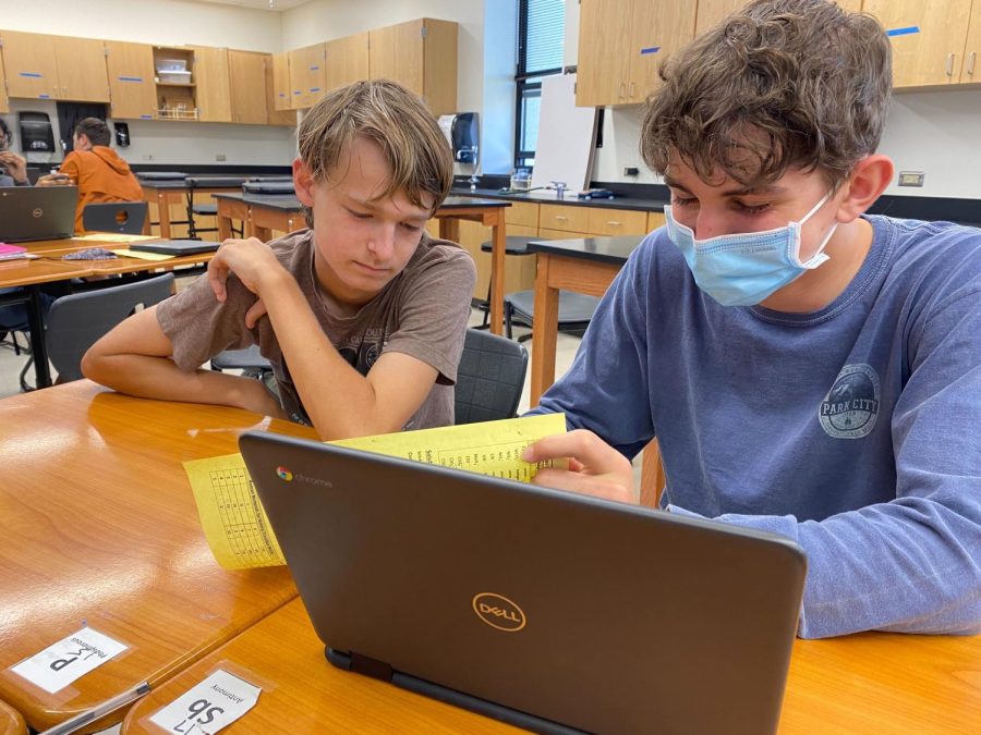 Using a periodic table to identify elements, students Fred Fisher 24 and Jacob Pryor 24 study together before their chemistry quiz. After the first nine weeks, many students coming back from virtual learning have been able to adjust to the various classes at Westwood.