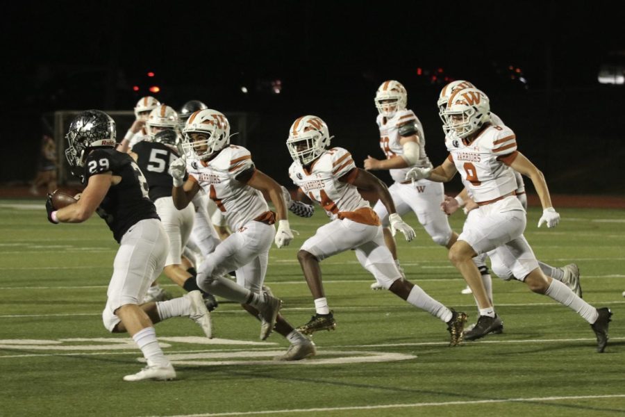 The Warriors try to stop their opponents from gaining yardage. However, they were unsuccessful, and the play resulted in a first down near the goal line for Vandegrift.