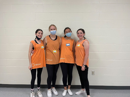 Zoe Bellomio ‘24, Meredith Strain ‘23, Susan Hamilton ‘23, and Claire Peptiprin ‘23 stand together for a photo halfway through the clinic. The clinic was lively throughout the three-hour time span. 
