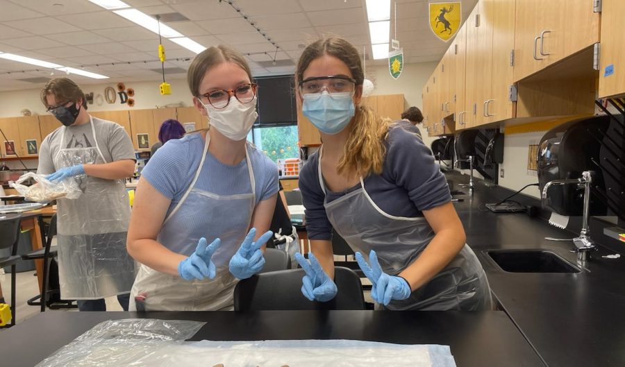 Aubrianna Carter '23 and Lucia Santaolalla '22 pose with their safety equipment on the first day of the lab. The students were required to wear it at all times.