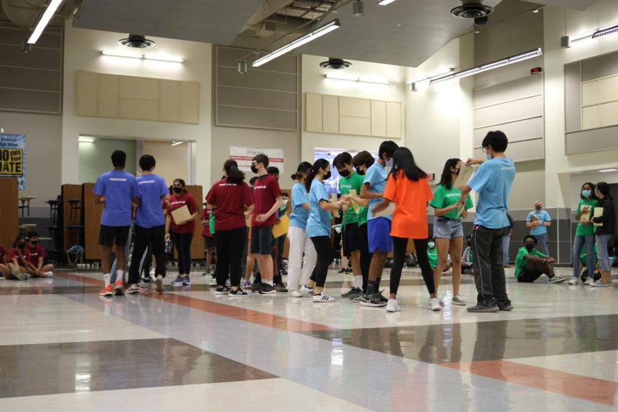 Chaos ensues in the makeshift stock exchange market as IB students rush to trade various commodities in a team-building exercise. The retreat included several bonding activities throughout the day.