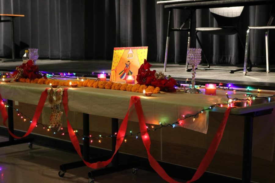 The spread in the front of the room held diyas, flowers, string lights, art, and chalices. The table at the front really brought the lights and attention to the student-led Diwali function. The decorations brought light into the room, and the art was a stunning addition. With the pooja altar being the first thing the attendees saw, it was such a beautiful piece to start the night out with.