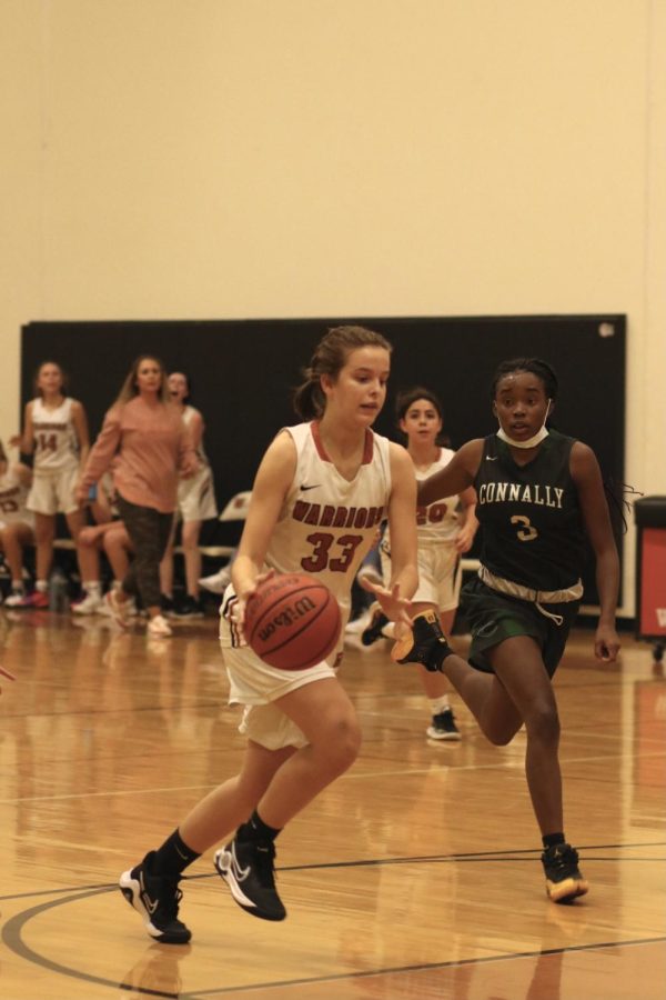 Ava Sartor 25 dribbles the ball. She was able to shoot and score two points for the Warriors.