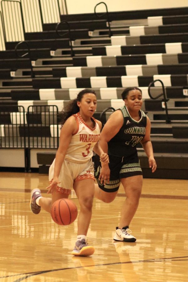 Nevaeh Arteaga 24 dribbles and shoots the ball. She was able to make her layup and earn two points for the Warriors.