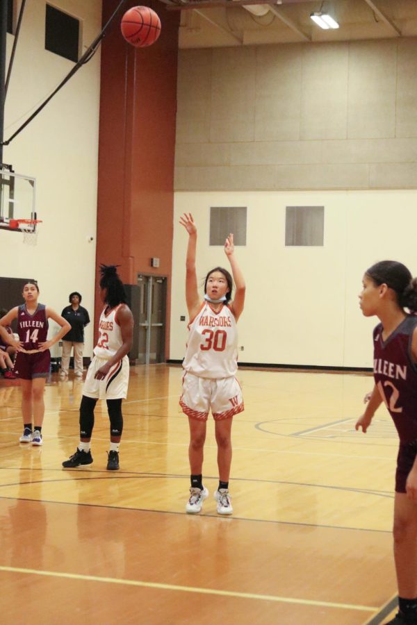Grace Chao 23 shoots a free throw. She was able to make both of her free throws and earn two points for the Warriors.