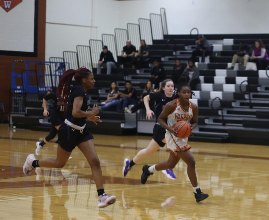 Mahogany Wright ‘23 runs down the court with Cedar Ridge opponents on her heels. Throughout the game the warriors were able to steal the ball, however the competition was tough and the warriors were defeated. “I think that’s the worst we’ve played in a long time. We gotta talk more on the transition of defense to offense,” said Wright. “They got easy points because of the lack of communication.”
