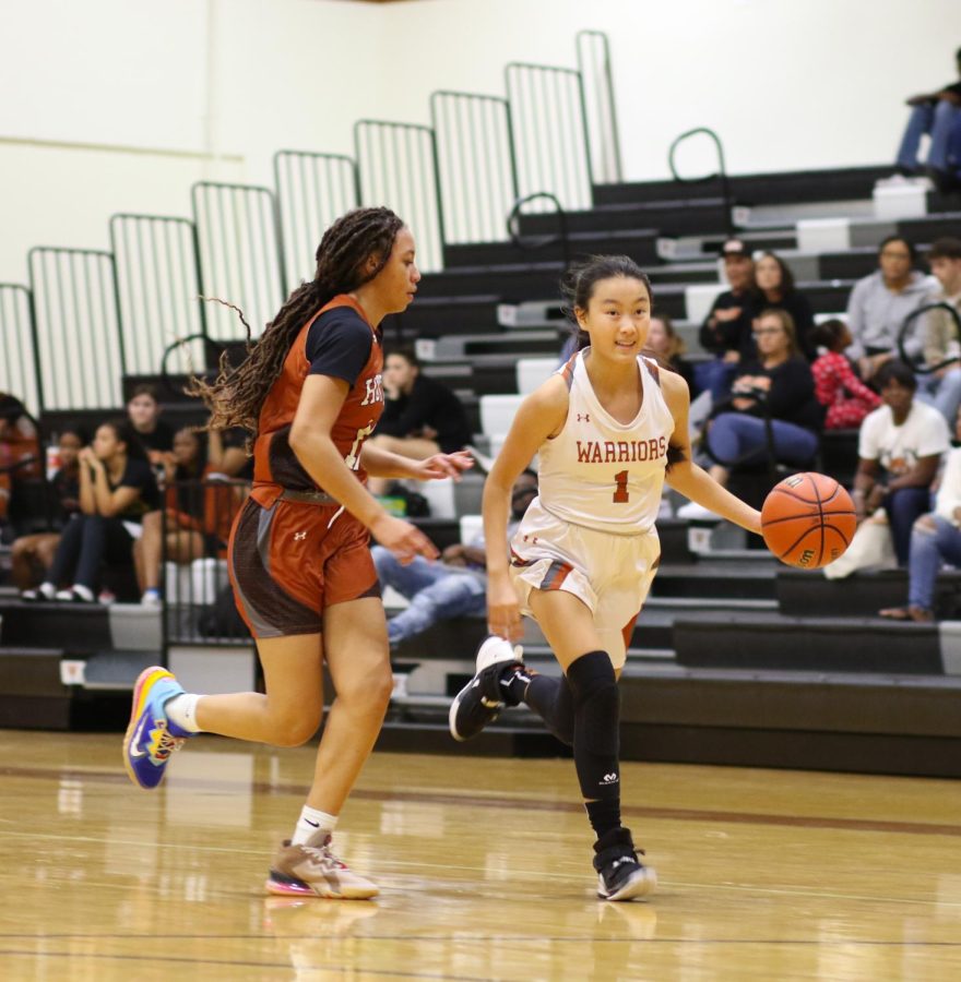 Running, Olivia Yang 23 makes a fast break for the net. Yang was successful in her layup attempt and earned Westwood another two points.
