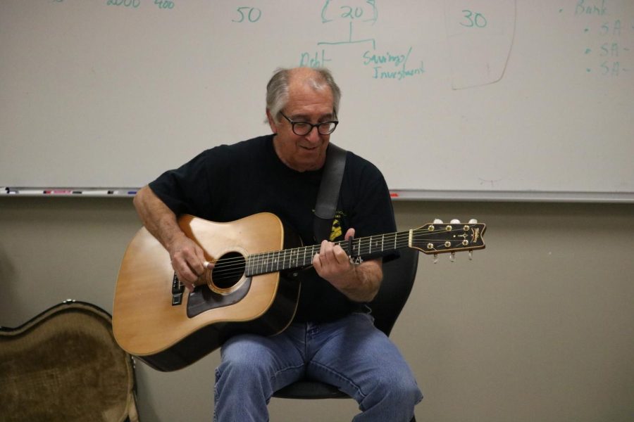 Demonstrating finger picking, Mr. White performs a song. He performed folk music. 