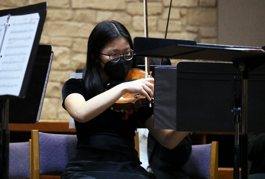 Re-adjusting her bow, Lori Chen 22 prepares to play in the pizzicato section of Point Lookout by Brian Balmages. The piece, a tribute to the rich history of Fort Lincoln during the American Civil War, features several recognizable themes. 