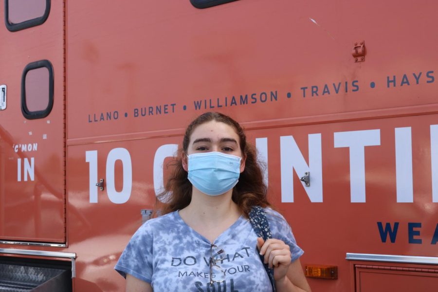 Bianca Cureau 22 poses in front of the bloodmobile after donating blood. 