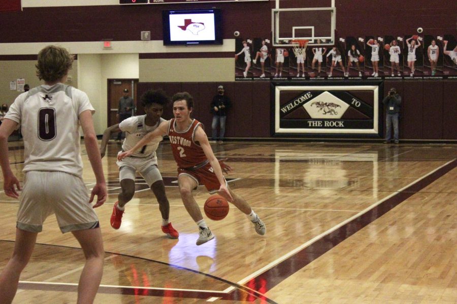 Dribbling past the Round Rock defenders, Karsten Bresser 22’ heads for the basket. I felt we played good as a team and everyone hit big shots when we needed them, Bresser said. It was a great game for our team overall.