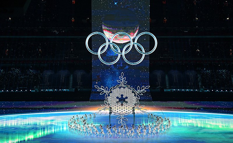 Performers dance around a LED screen snowflake, which represents the theme of the 2022 Winter Olympic opening ceremony, One World, One Family. Photo courtesy of Wikimedia Commons.