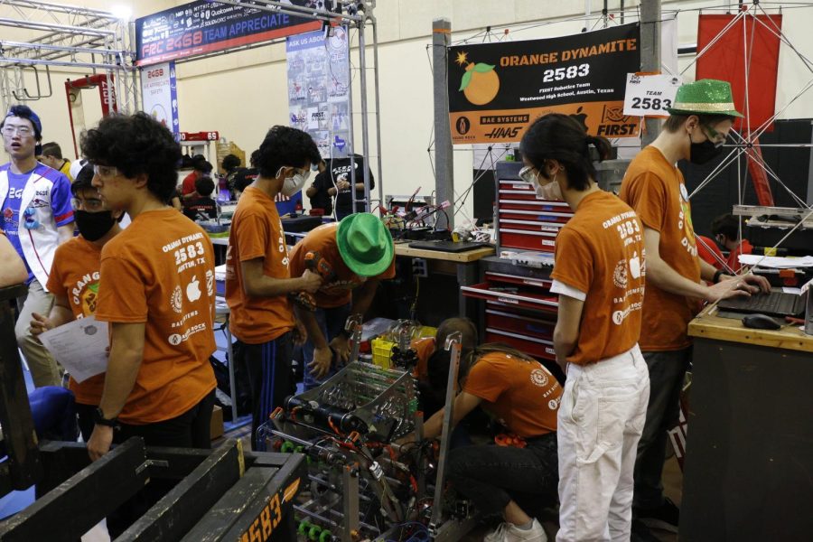 As the builders come into their assigned workspace, they check up on their robot and fix wire damage. As robotics competitions usually include many robots hitting and bumping into each other, most teams spend all their time in-between matches fixing any breaks. Photo courtesy of Westwood Robotics.